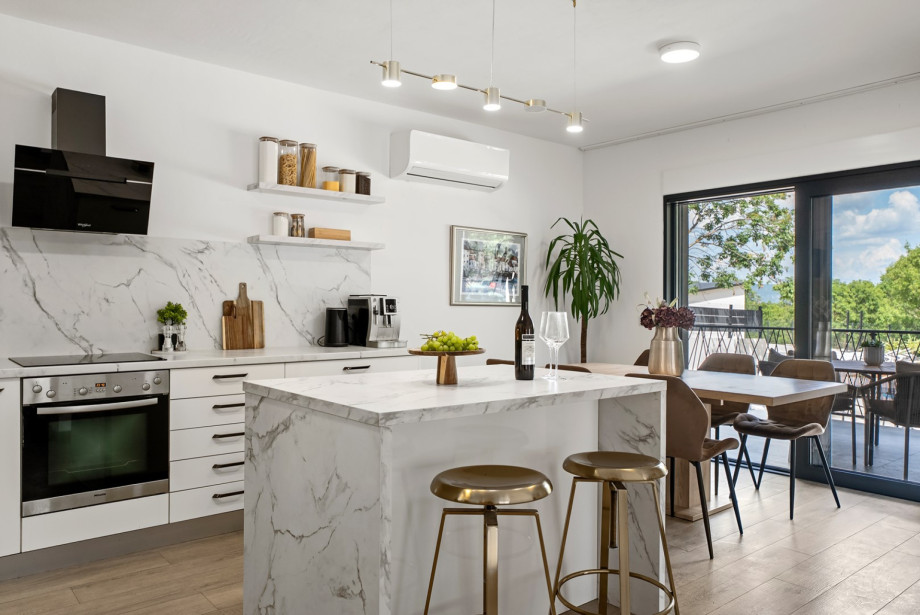 A fully equipped kitchen with a stylish kitchen island, high-quality appliances, and generous workspace, offering everything needed to create memorable culinary experiences.