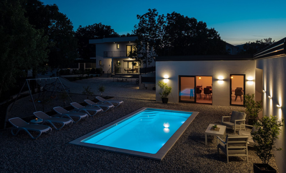 A spacious terrace with outdoor furniture offers pool views.