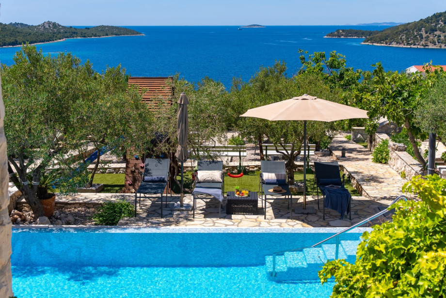 A short walk from the pool area leads to the garden and kids' play zone.