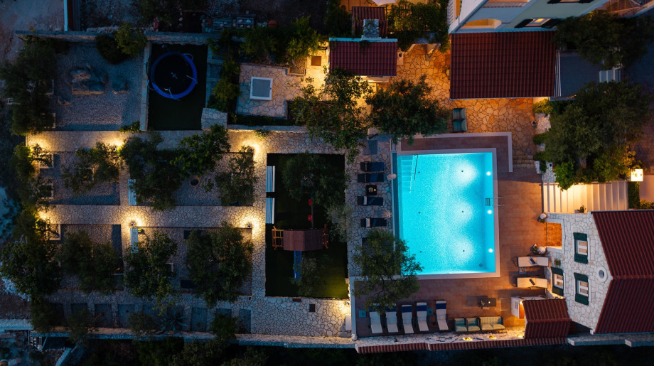Landscaped 1.500 m2 private plot combining olive trees with a kids play zone.