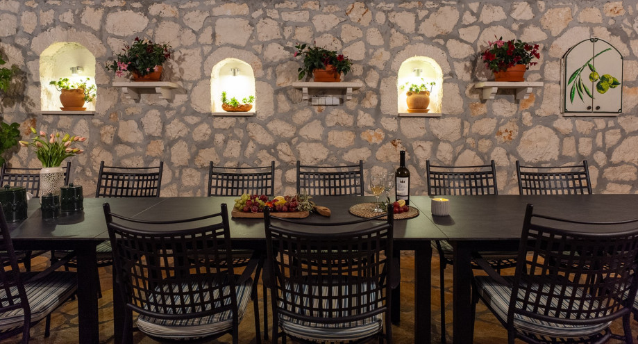 Covered outdoor dining area with a large table that accommodates up to 14 people.