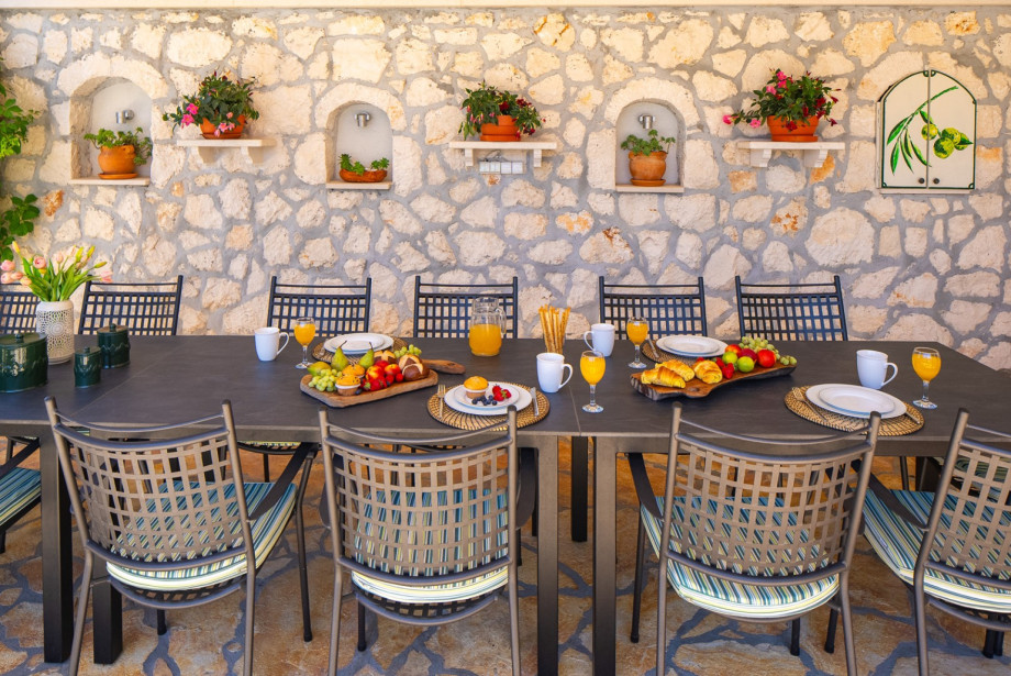 Covered outdoor dining area with a table that accommodates 14 people.
