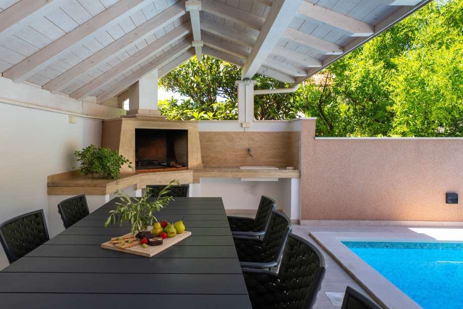 Covered terrace with dining area for 8 pax; another dining area for 8 pax next to the traditional barbecue