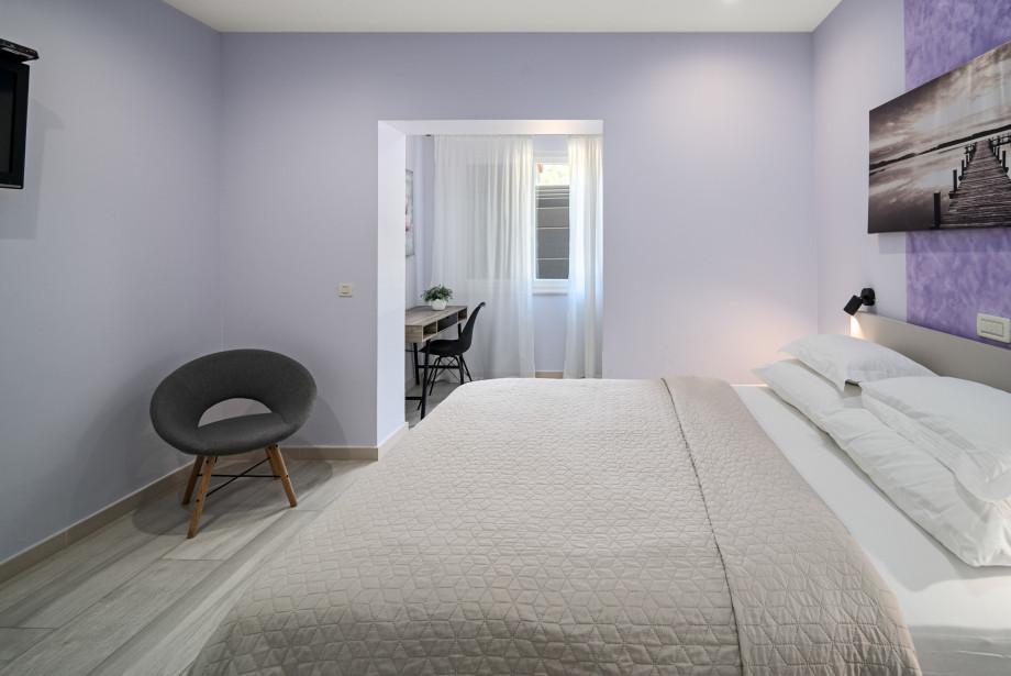 Bedroom No.2 on the ground floor with a king-size bed, AC and a TV
