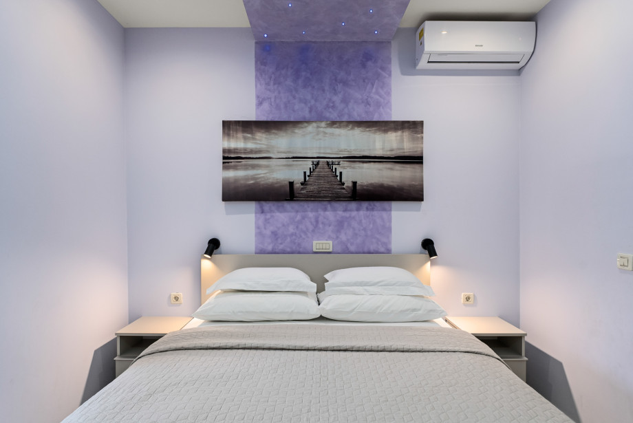 Bedroom No.2 on the ground floor with a king-size bed, AC and a TV