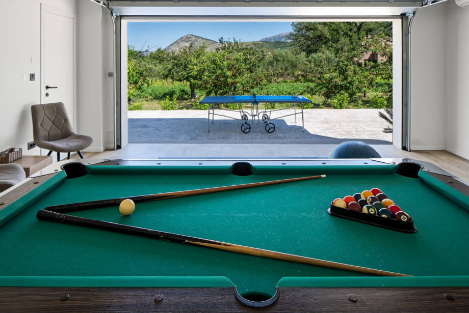 The villa features a dedicated entertainment zone with a pool table.