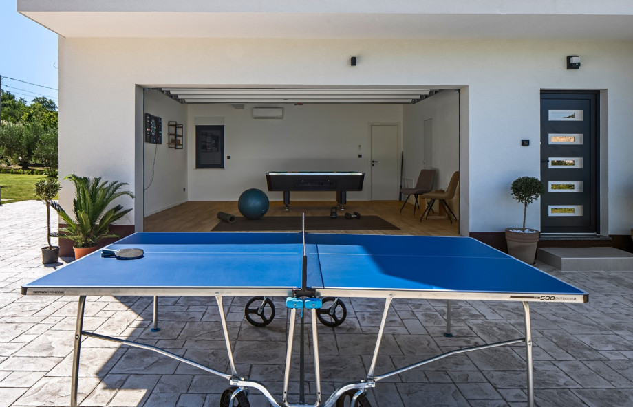 The villa features a fun entertainment space where guests can enjoy a game of table tennis.