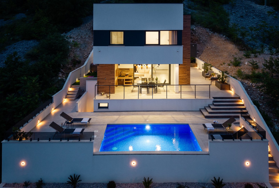 With 226 sqm of useful interior space organized across three levels, this villa sits on a private plot of 450 sqm