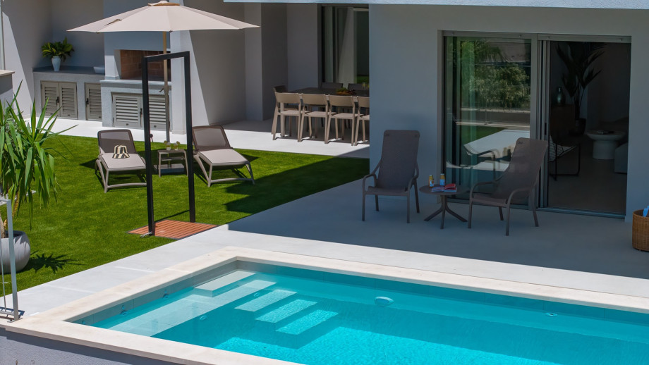 Pool is equipped with a hydromassage system for ultimate relaxation.