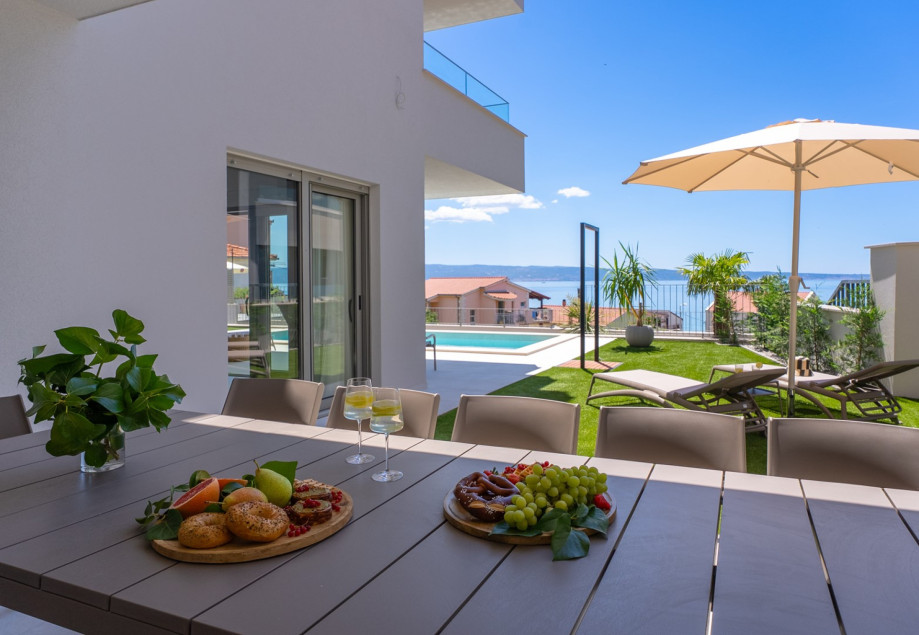 Enjoy open-air meals with views of the sea and Brač island.