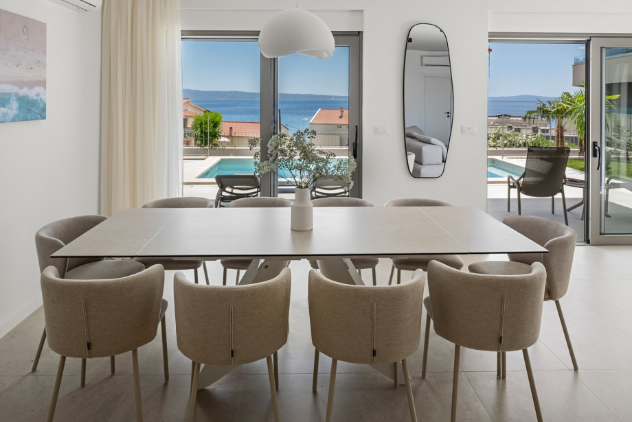 Large dining table sits inside the open-plan space for family meals.