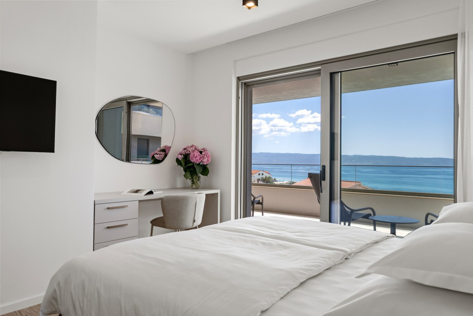 Large windows frame beautiful sea views directly from the king-size bed.