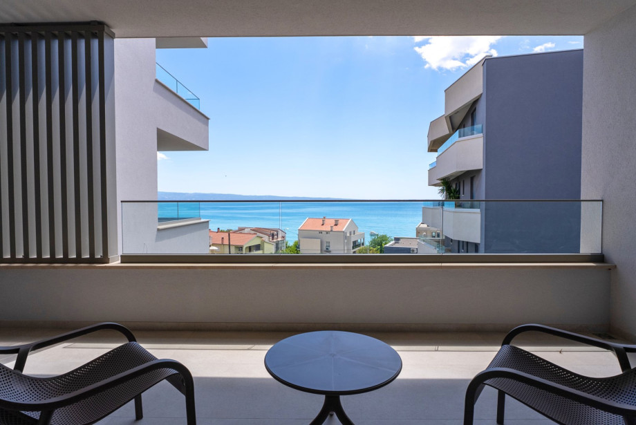 The room includes a terrace complete with lounge chairs.