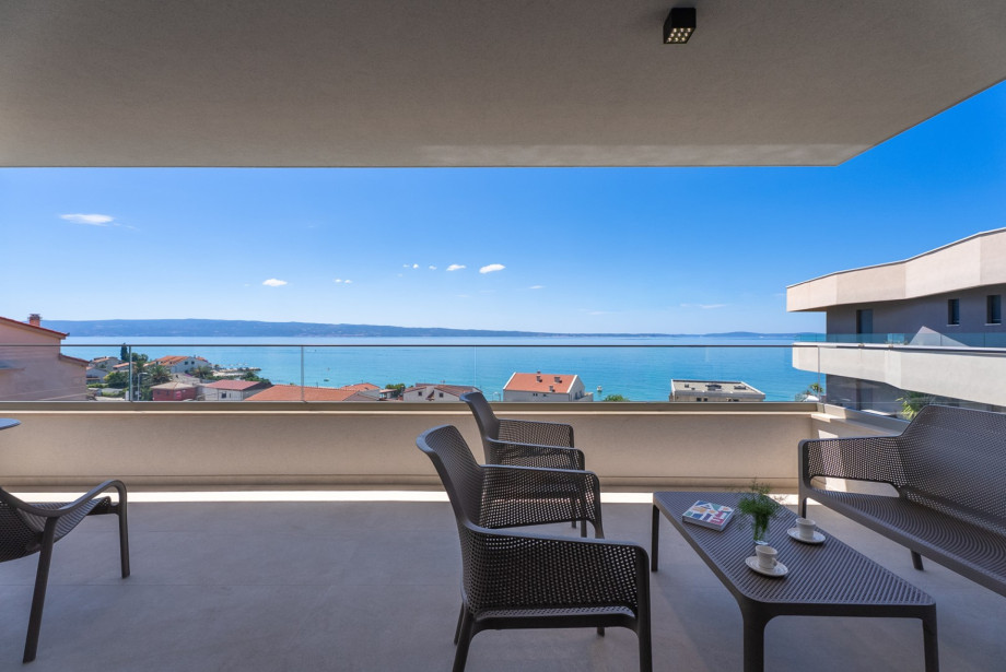 Terrace opens directly from the living room, offering wide sea views.