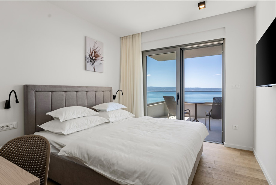 Cozy 11.3 sqm bedroom No.4 on the second floor with a king-size bed and AC.