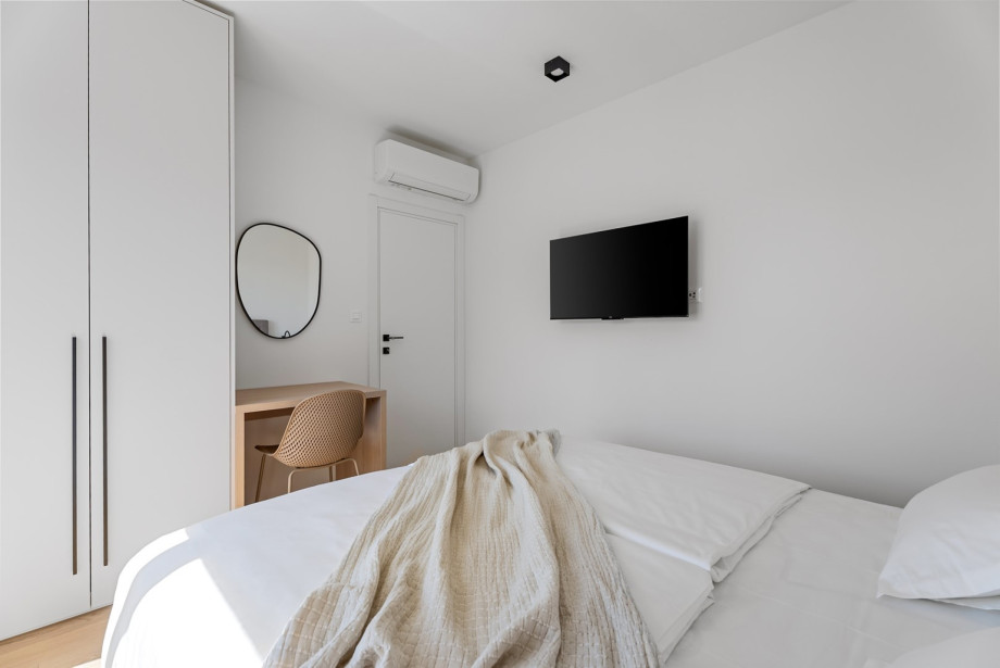 Fully air-conditioned space equipped with a wall-mounted flat-screen TV.