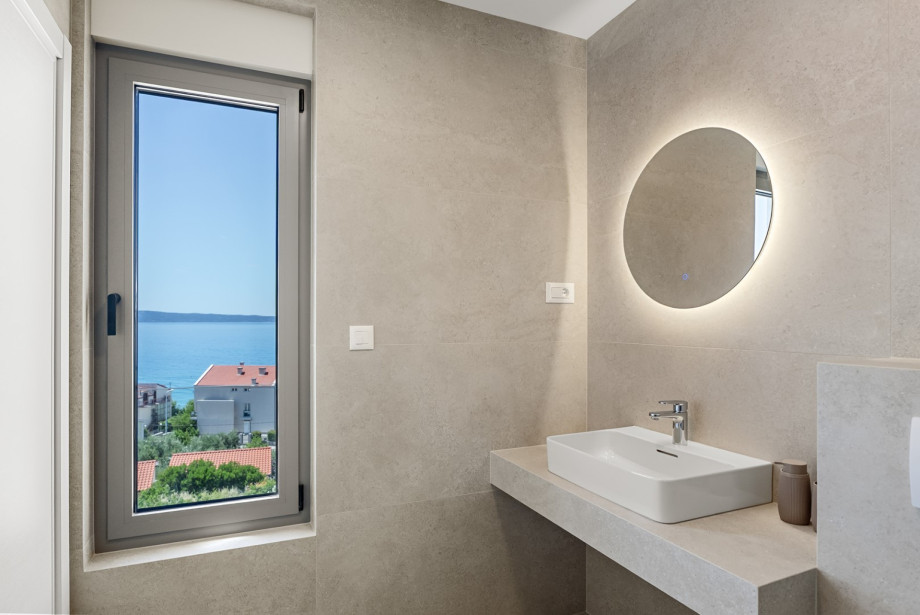 En-suite bathroom features a walk in shower and modern fixtures.