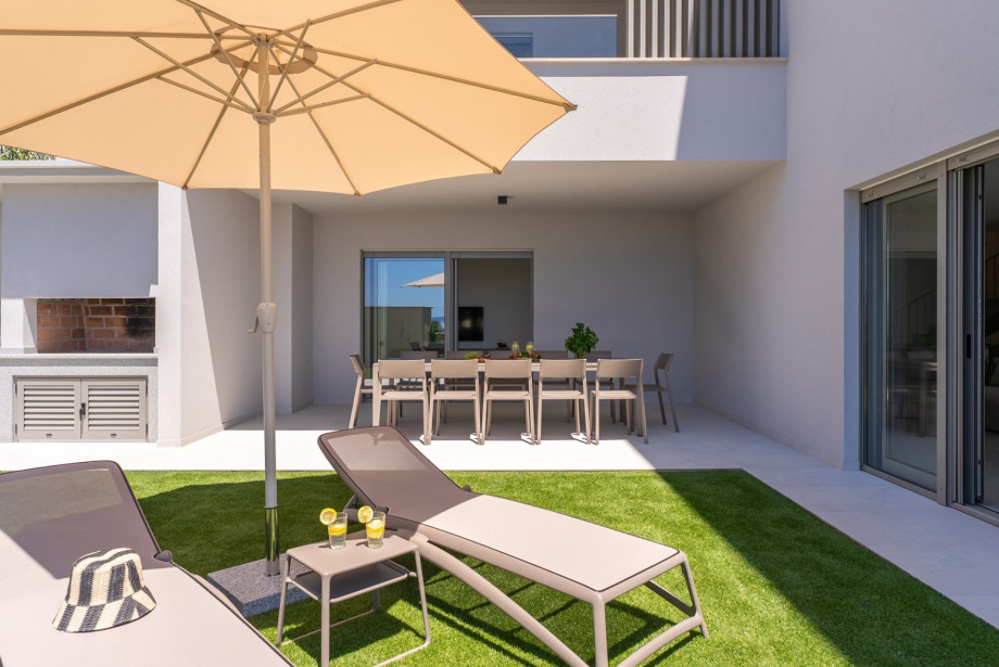 Spacious sun deck is covered in neat artificial grass right next to the pool.
