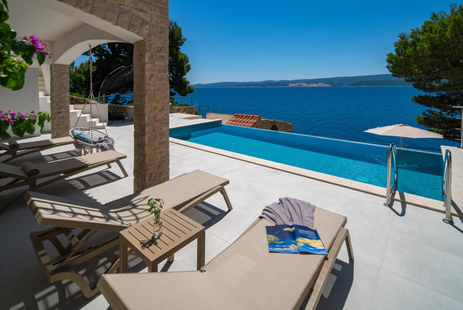 Main sun deck surrounding the pool is equipped with eight comfortable deck chairs.