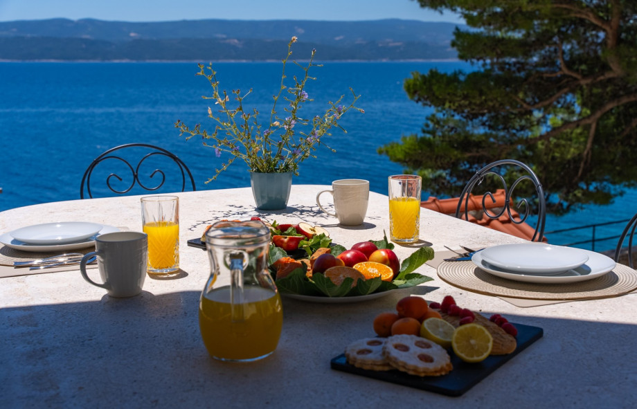 Dining alfresco by the pool provides perfect sea views.