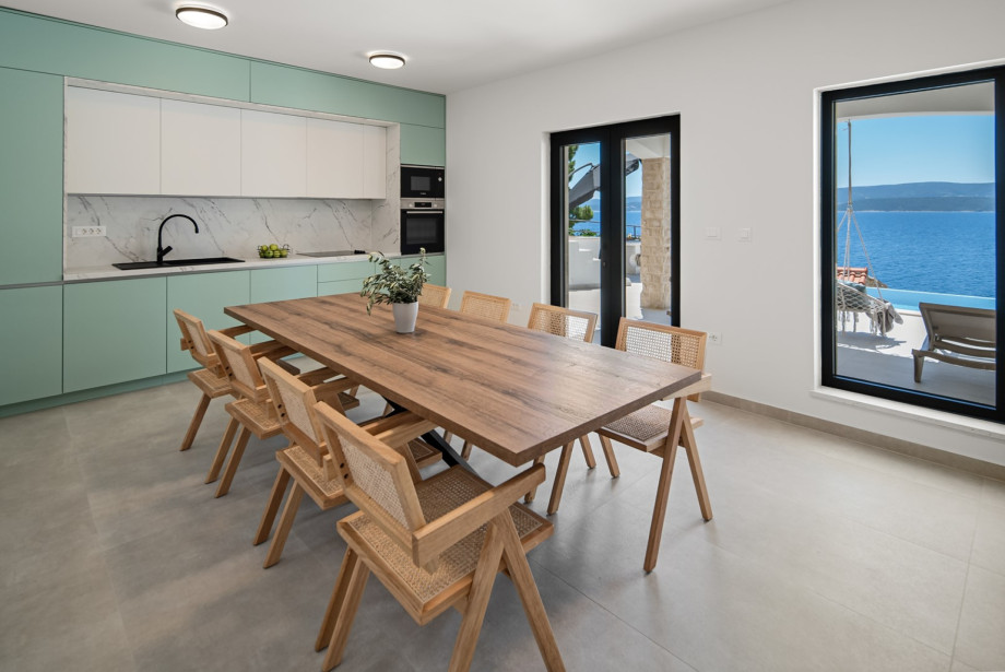 Fully equipped kitchen features modern appliances and a large two-door fridge.