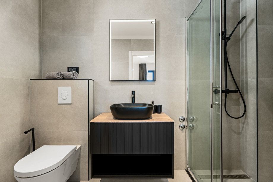 The room includes a private en-suite bathroom fully equipped with a modern shower.