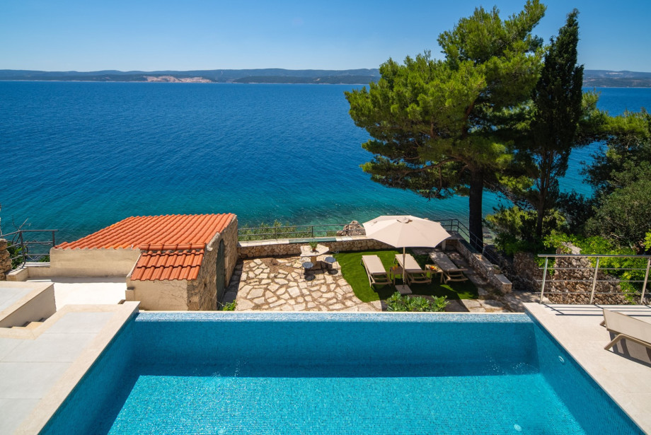 A smaller sun-deck area is located just a few steps down from the main terrace.