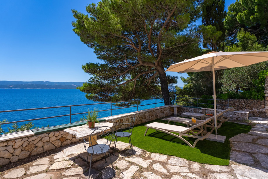 The lower sun-deck zone offers a shaded area away from the main pool deck.