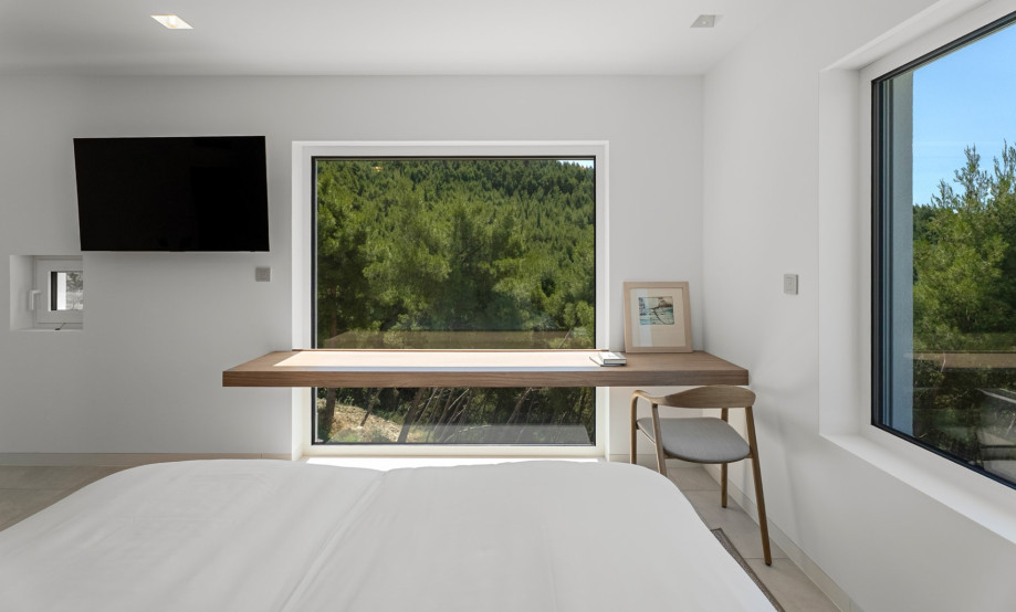 The minimalist design, comfortable bed, and natural light create a calm setting for restful nights