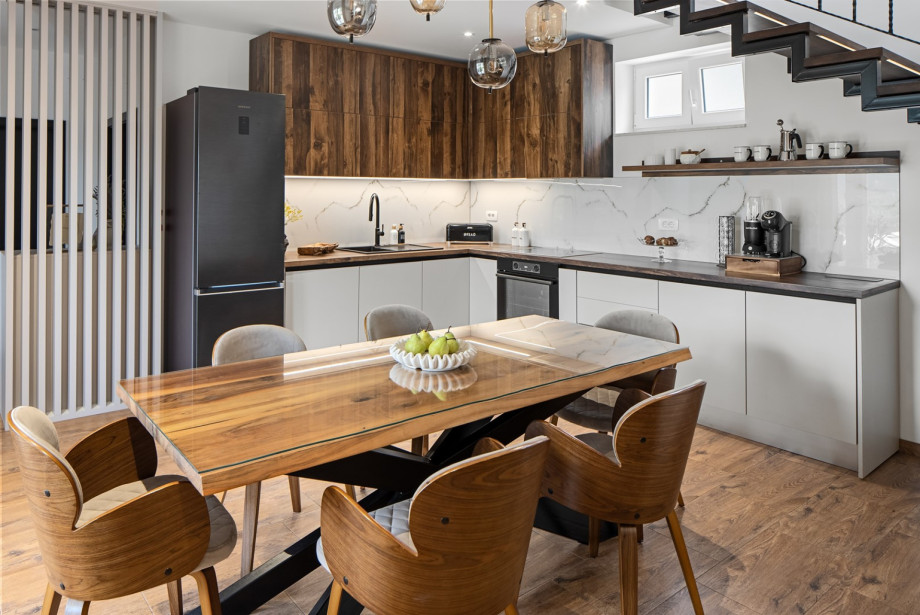 The open-plan kitchen is equipped with all the appliances and utensils needed for a comfortable stay