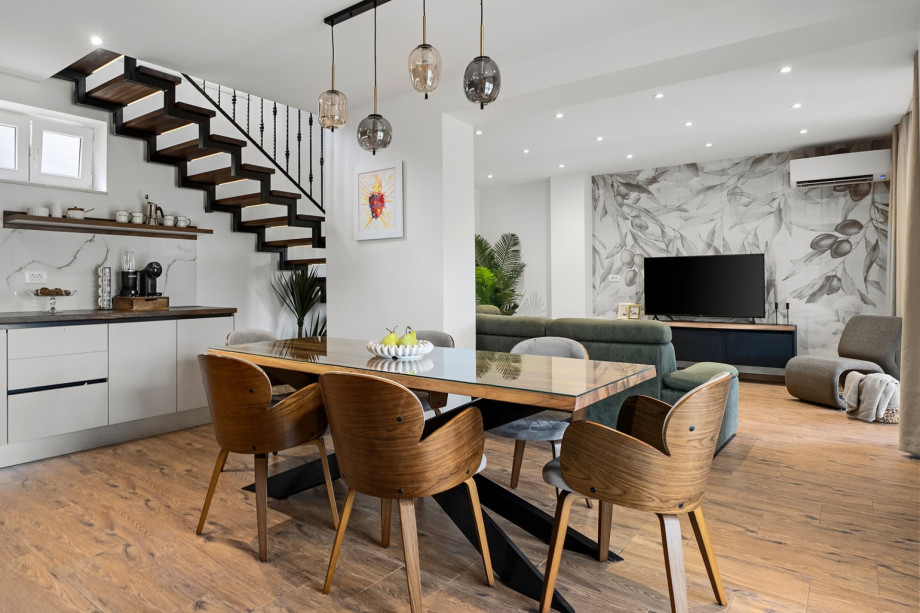 Complemented by a dining table for eight guests.