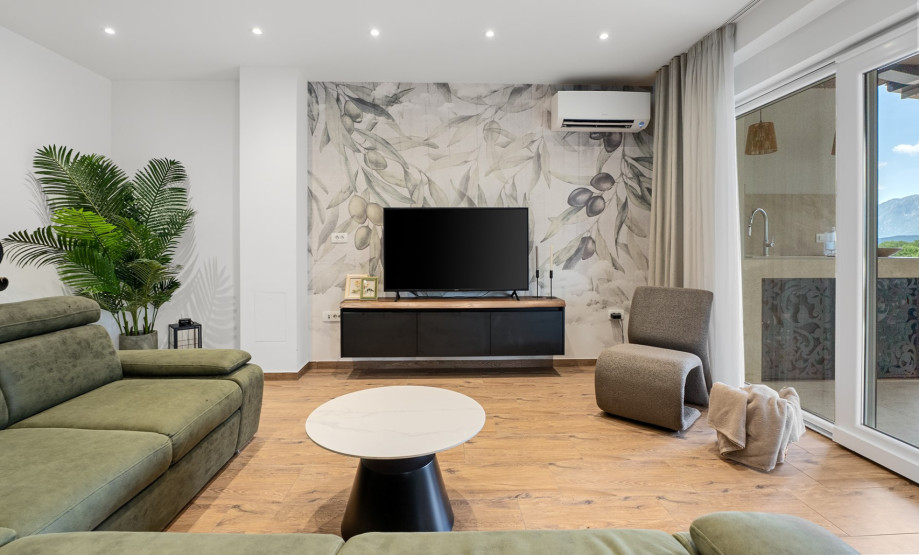Modernly decorated, air-conditioned living room overlooking the pool and private garden