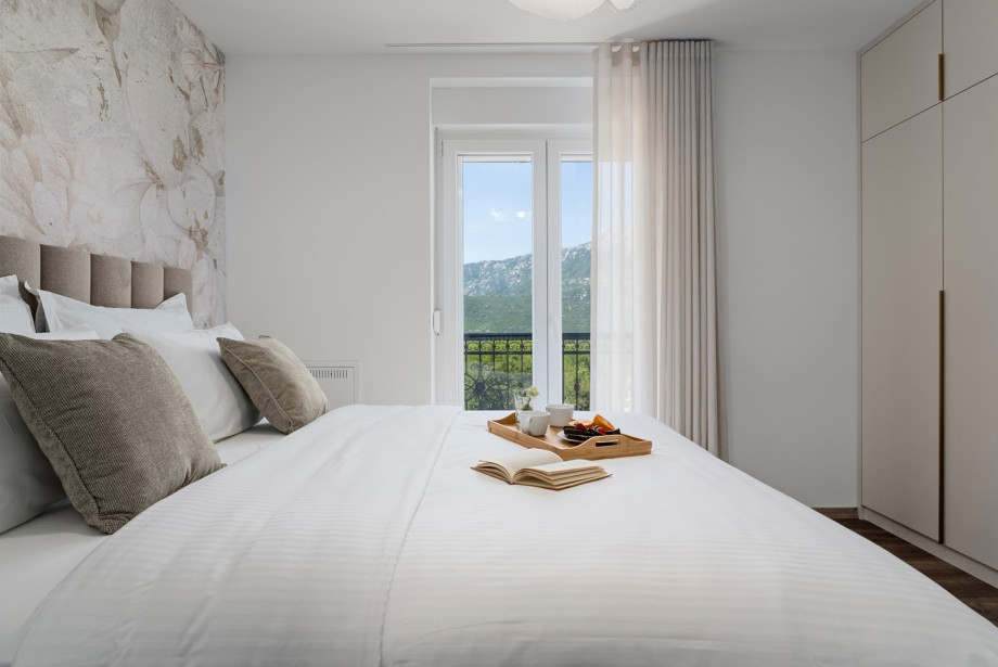 Modernly decorated, air-conditioned bedroom with mountain and landscape views