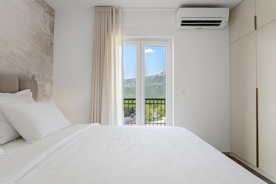 Modernly decorated, air-conditioned bedroom with mountain and landscape views