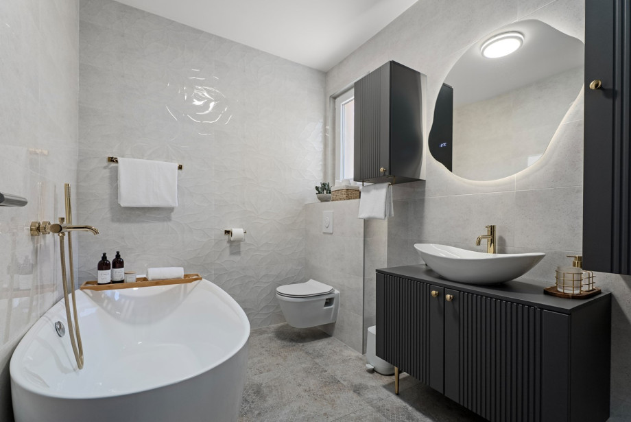 The family bathroom is modernly decorated and is located right next to the rooms.