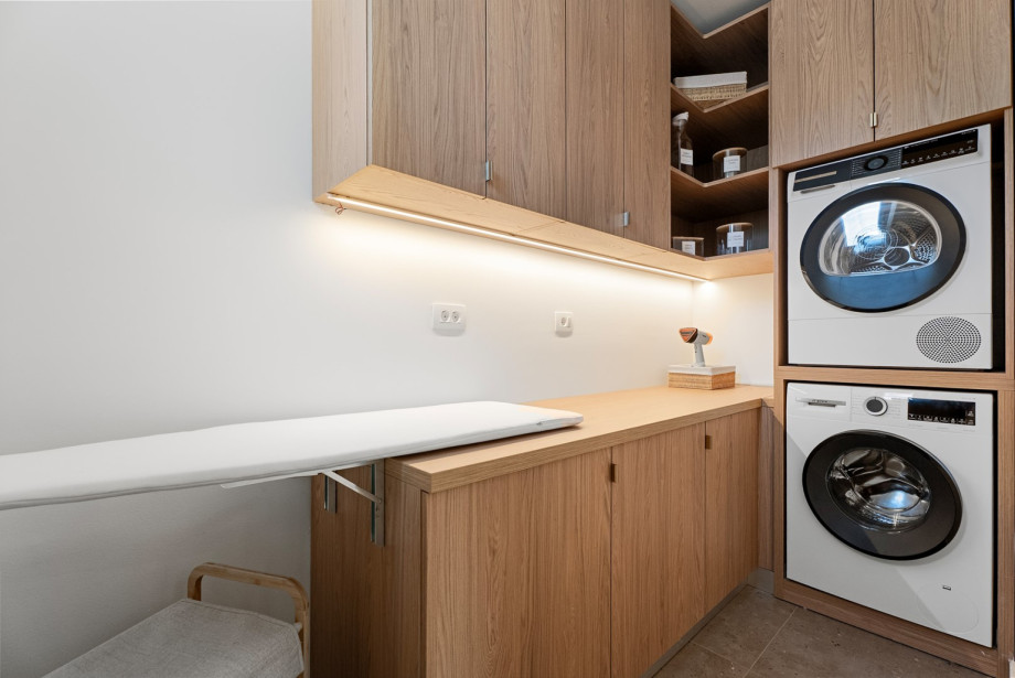 A fully equipped laundry room ensures convenience during your stay, with a washing machine, dryer, and ironing facilities.