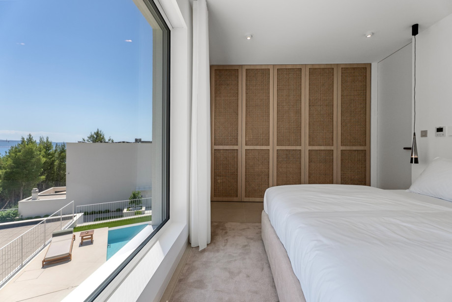 Das minimalistische Design, das bequeme Bett und das natürliche Licht schaffen eine ruhige Atmosphäre für erholsame Nächte