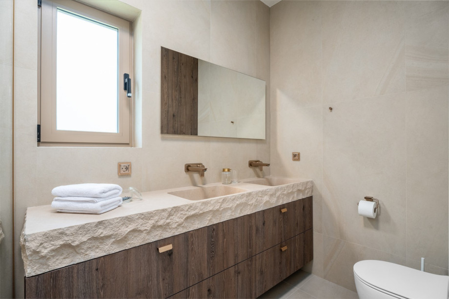 An en-suite bathroom with a bathtub, a shower, a sink, and a toilet