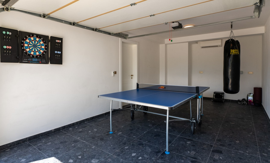 Within the garage area is a table tennis and pilates ball that can be accessed from both the inside and the outside