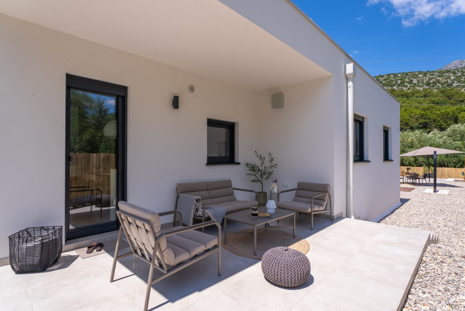 The lounge area is situated in front of the kitchen, providing a perfect spot for a morning coffee