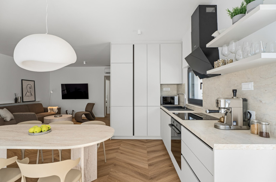 The kitchen comes equipped with an espresso coffee maker, microwave oven, refrigerator, kettle, and more essential appliances