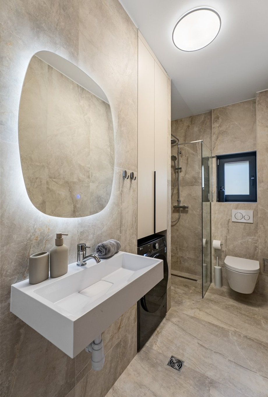 The second family bathroom (5 sqm) offers a shower, sink, toilet, and a washer/dryer combo and iron with ironing amenities.