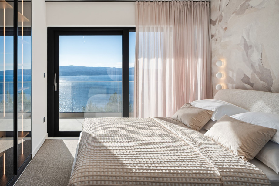 Experience unparalleled comfort and breathtaking Dalmatian coast vistas from this room, featuring a queen-size bed and sliding glass doors leading to the exterior.