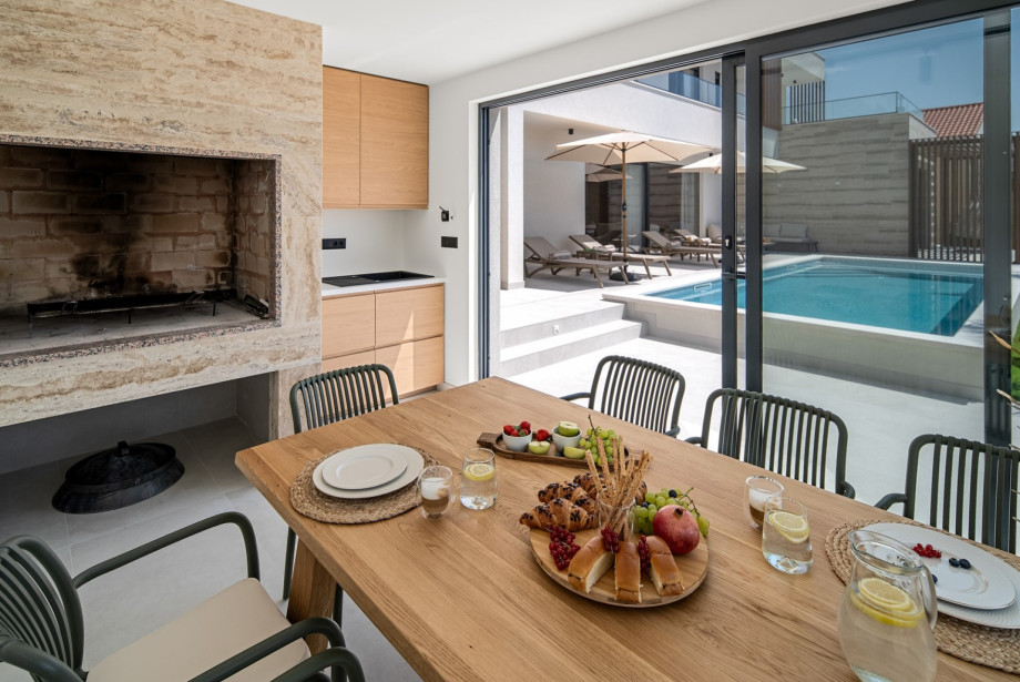 A summer kitchen with dining area and barbecue