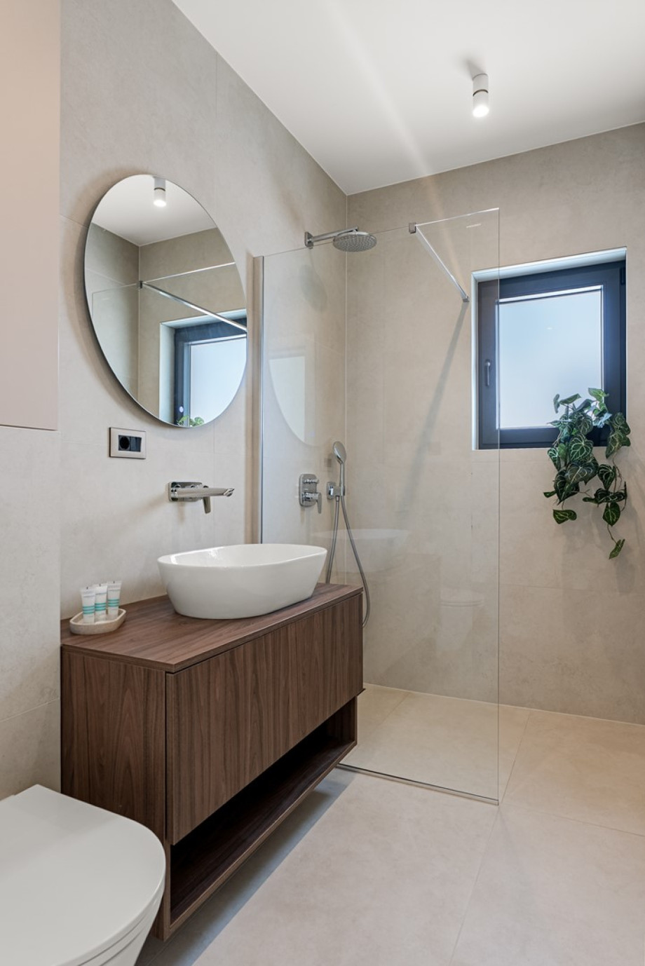 An en-suite bathroom with a shower, a sink, and a toilet