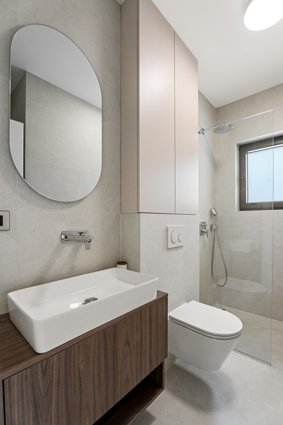 There is a family bathroom with a shower, a sink and a toilet
