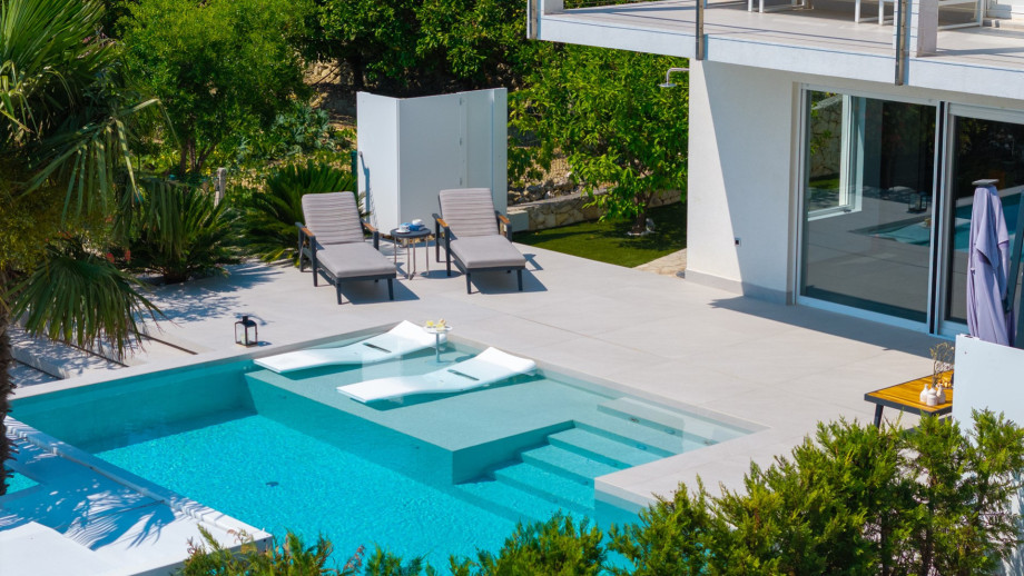 The comfortable sun deck area around the infinity pool with very comfortable sun-deck chairs