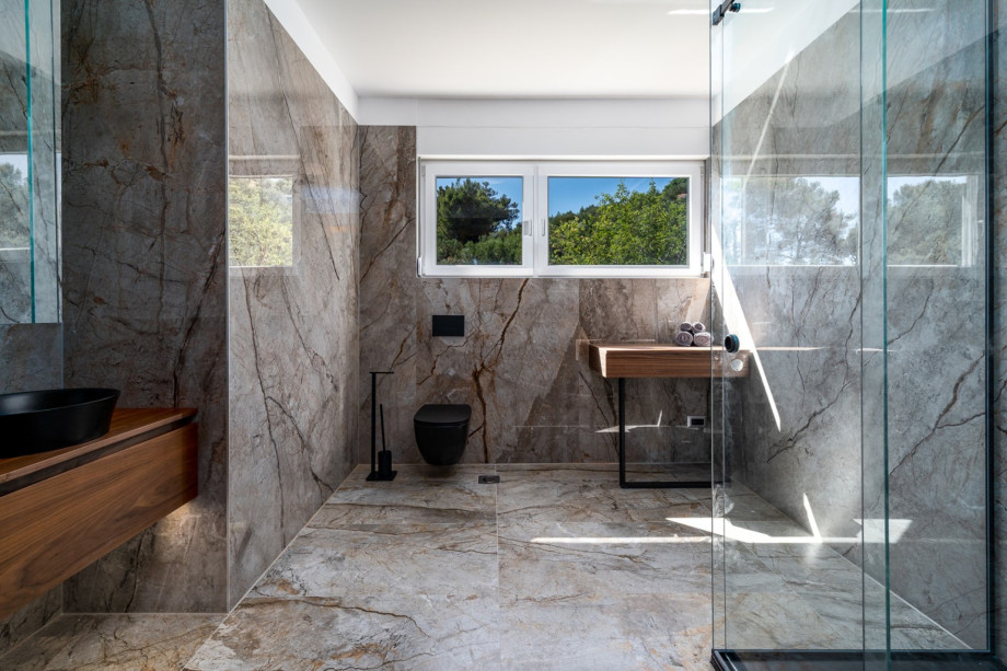 A spacious family bathroom with a shower (for Bedroom No 3 and No4). There is also a laundry with a washing machine, a dryer and ironing facilities.