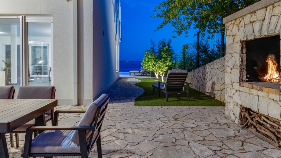 Outdoor dining area with a barbecue set the scene for unforgettable evening gatherings