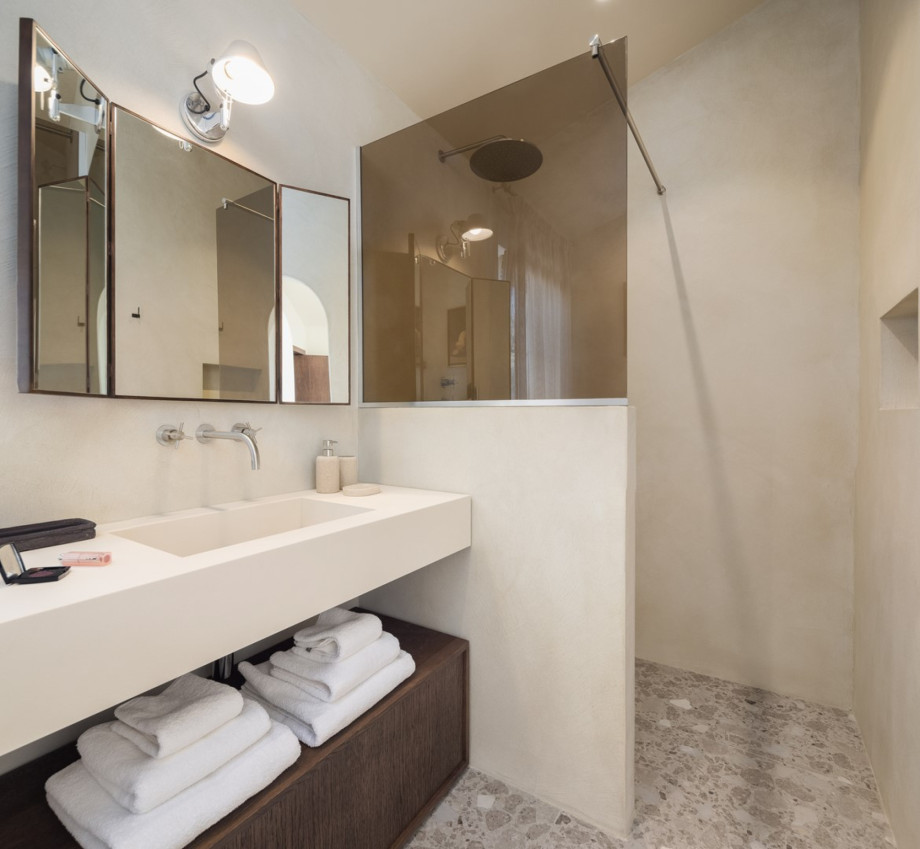 An en-suite bathroom with a shower, a sink, and a toilet